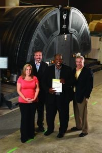 In-line finishing on the inkjet presses—comprising a buffer, cutter, separator and stacker—has greatly enhanced productivity and efficiency. From left: Eric Seldon, Gillian Seguin, Frank Butler and Mike Thomas.